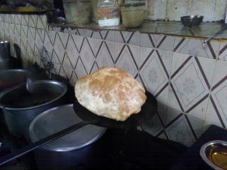 Here is a Poori straight from the oil. Nice and fluffy. Fun thing is you get the flatten it before eating :-)